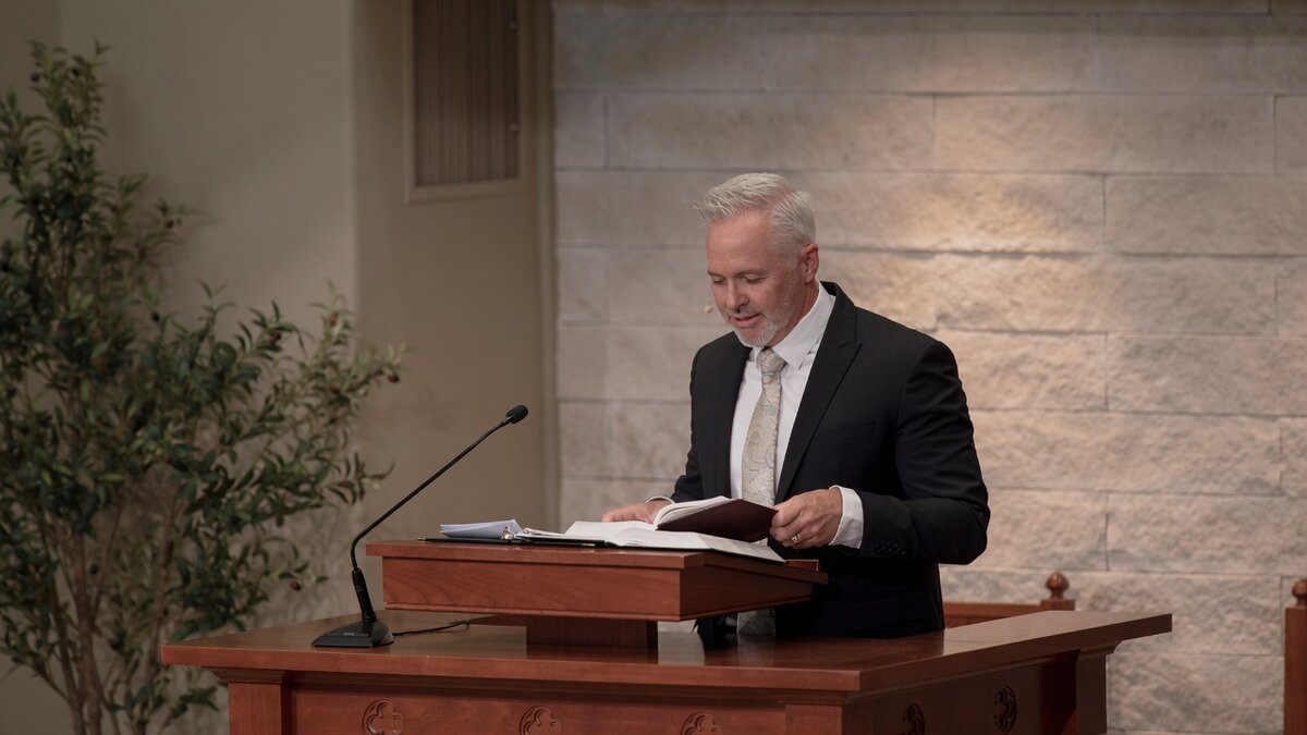 Rev. Christopher Gordon preaching from Scripture during worship